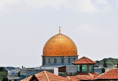 Dome of the rock and buildings against sky.