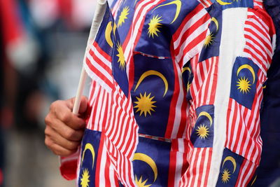 Cropped hand of person holding flag