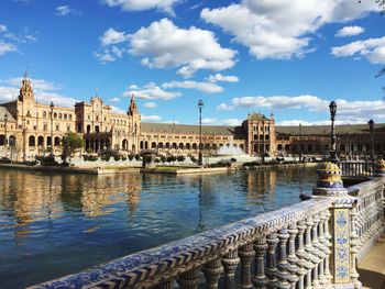 Canal by plaza de espana against sky