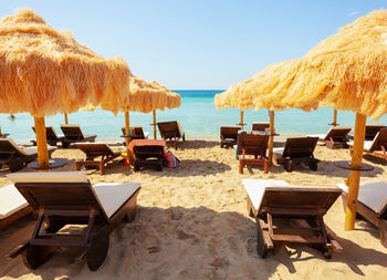 Beach beautiful thatched umbrellas and turquoise sea.