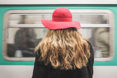 Rear view of woman with red hat