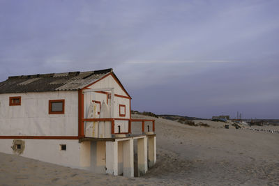 House on beach against sky