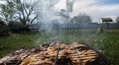 View of meat on barbecue grill