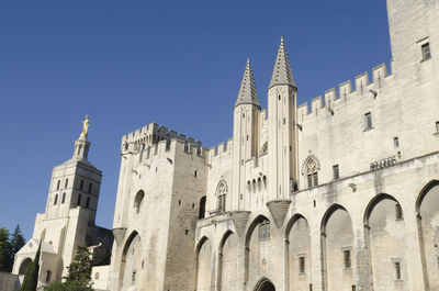 Low angle view of historic building against clear blue sky