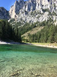 Scenic view of lake by trees against mountain