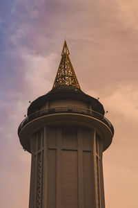 Low angle view of tower against sky during sunset