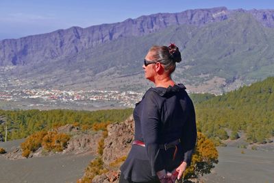 Rear view of woman looking at mountains