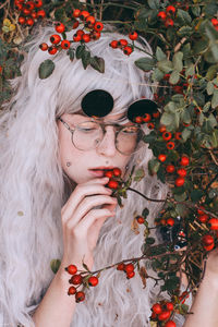 Close-up of woman hand with red flowers