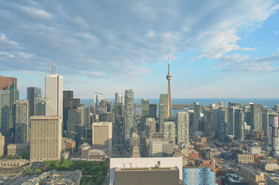 Modern buildings in city against cloudy sky