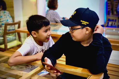 Smiling boy talking to brother