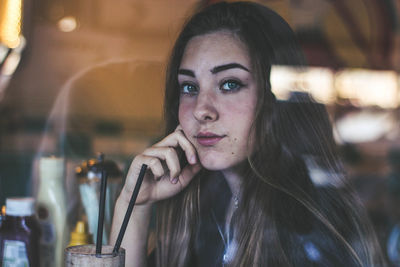 Portrait of young woman drinking glass