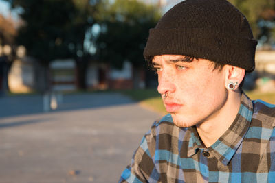 Handsome boy with blue eyes wearing beanie an plaid shirt