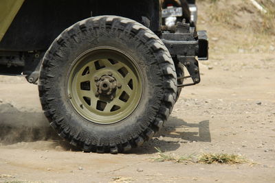 Close-up of vintage car on dirt road