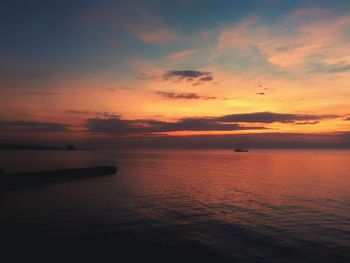 Scenic view of sea against orange sky