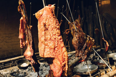 Close-up of meat hanging on barbecue grill