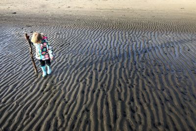 High angle view of woman standing on beach