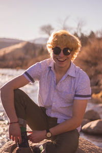 Portrait of man wearing sunglasses standing outdoors