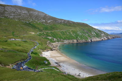 High angle view of sea and mountains against sky