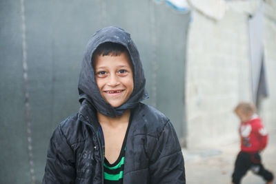 Portrait of happy boy standing outdoors