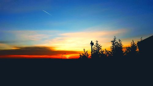 Silhouette trees against sky during sunset