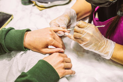 Women's hands in the manicure process close-up