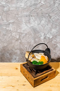 Close-up of food on table against wall