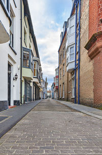 Empty alley amidst buildings in city