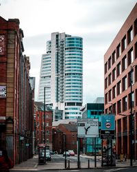 Buildings in city against sky