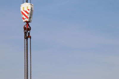 Low angle view of crane against sky