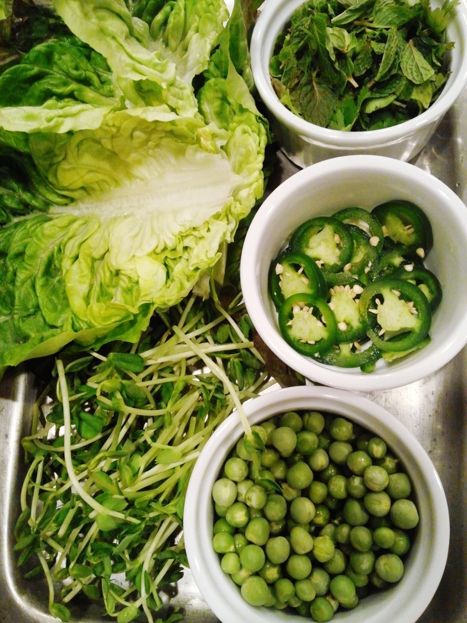 food and drink, food, healthy eating, freshness, green color, vegetable, high angle view, bowl, abundance, organic, leaf, still life, green, indoors, close-up, large group of objects, no people, container, variation, salad