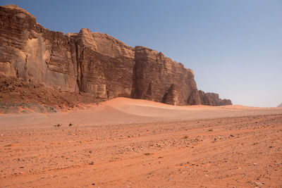 Sand dunes and sandstone cliffs in wadi rum desert , jordan