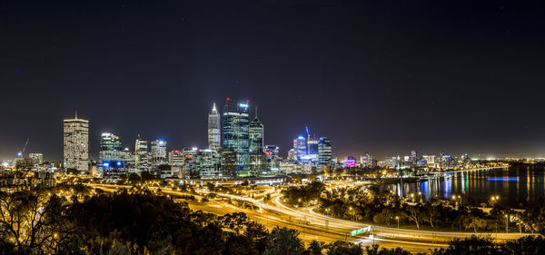 High angle view of city lit up at night