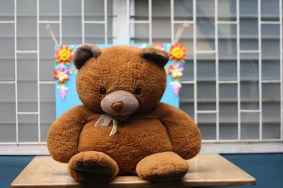 Close-up of stuffed toy against wall at home