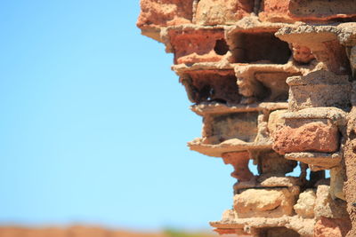 Close-up of stone wall against clear sky