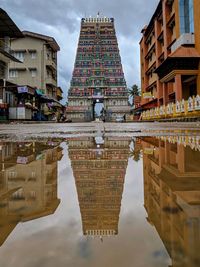 Reflection of buildings in puddle