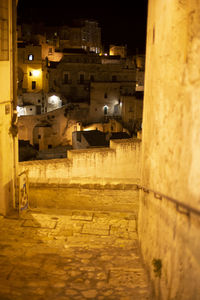 High angle view of illuminated alley amidst buildings in city