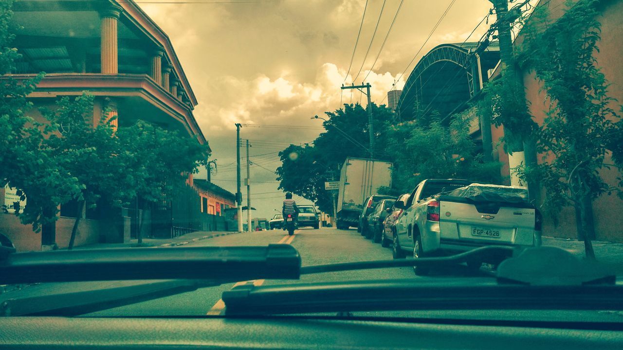 CARS ON ROAD AGAINST SKY