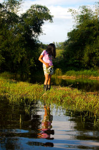 Rear view of man standing in puddle