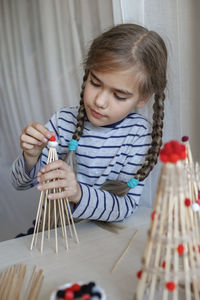 Cute girl playing with christmas ornaments