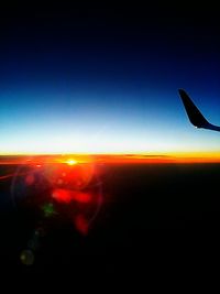 Close-up of airplane wing against clear sky