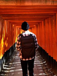 Rear view of woman standing on footpath