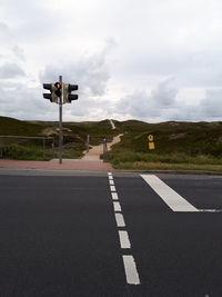 Road sign against sky