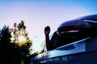 Close-up of cropped car against clear sky