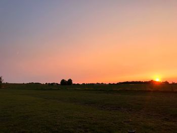 Scenic view of field against sky during sunset