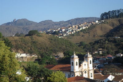 Houses in town against clear sky