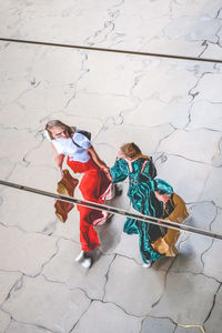 High angle view of people reflecting in curved mirrors 