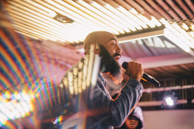 Low angle view of young man using mobile phone