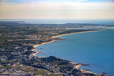 High angle view of city by sea against sky