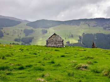 Built structure on field against sky