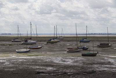 Boats moored on sea against sky